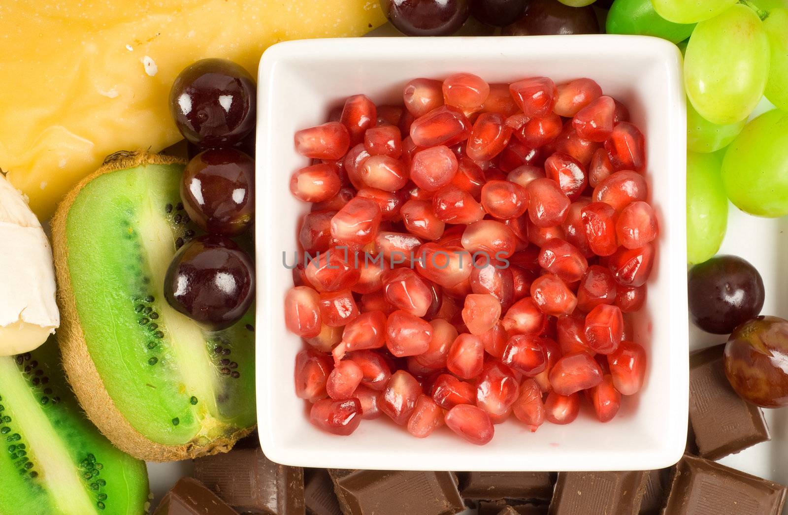 Cheese and fruit platter with pomegranate; grapes and kiwi fruit