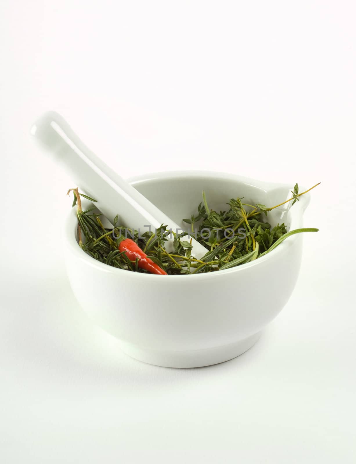 Mortar, pestle, herbs and peppers by alistaircotton