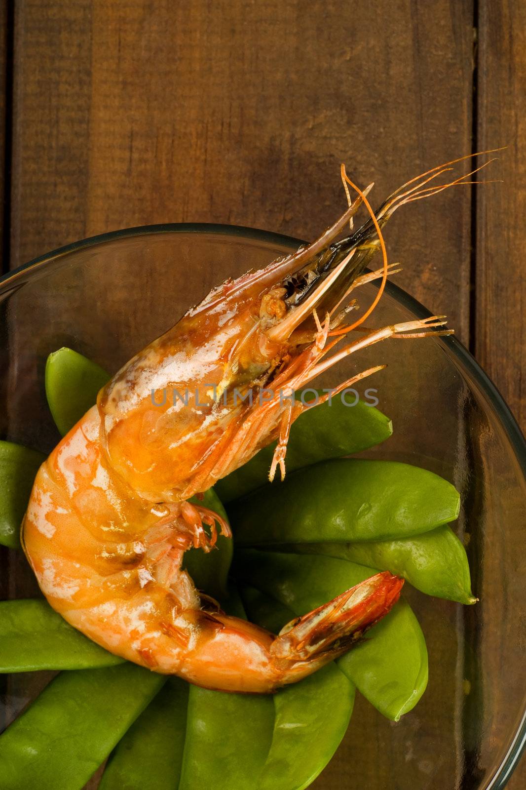 Cooked prawn on bed of green peas or beans