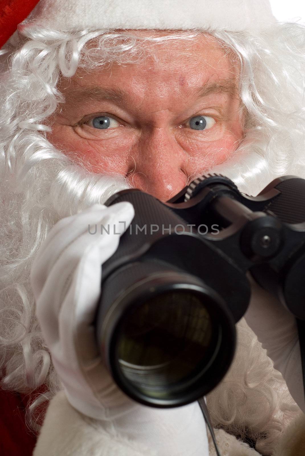 Close up Father Christmas with a questioning look in his eye and binoculars