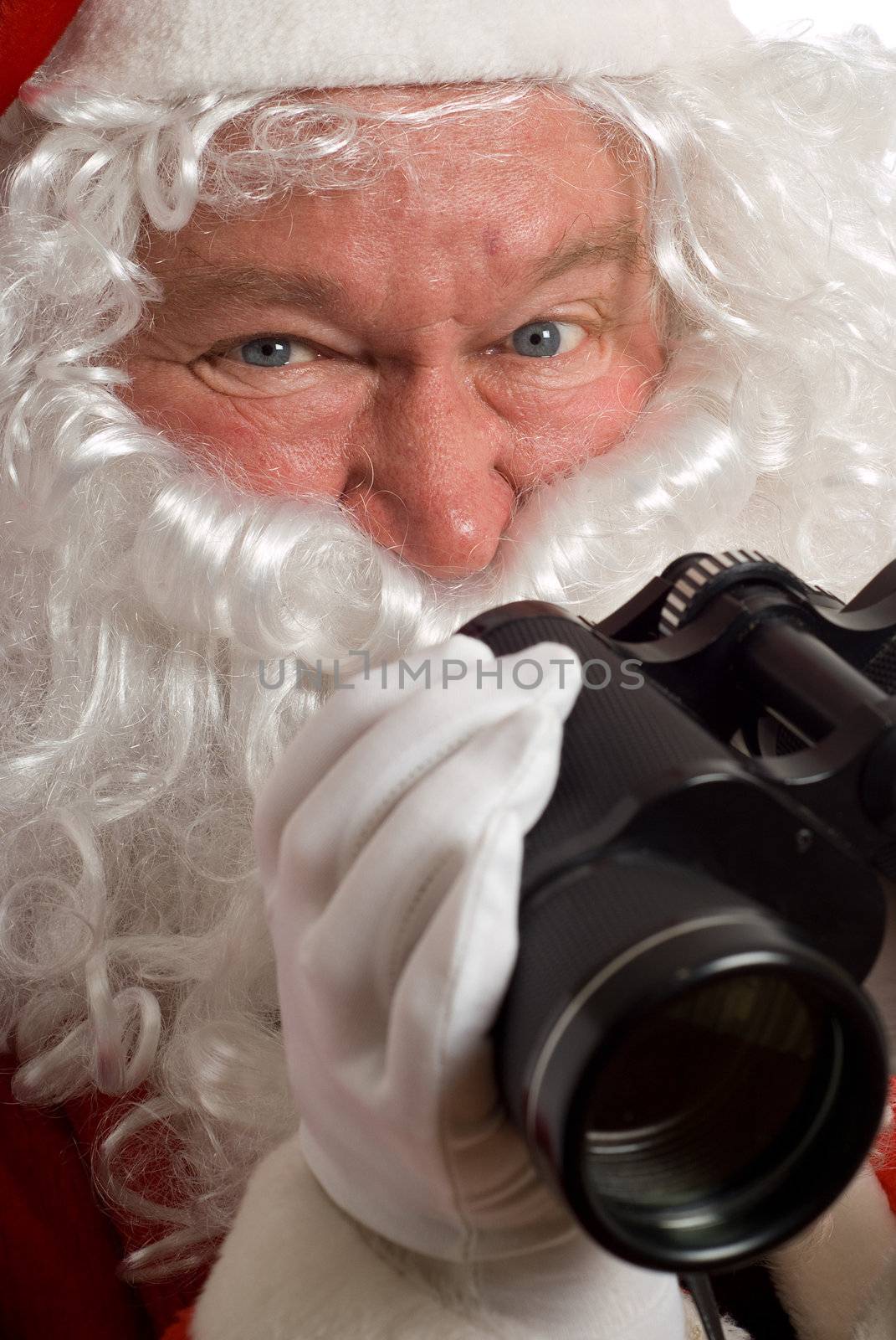 Close up Father Christmas with an odd look in his eye and binoculars