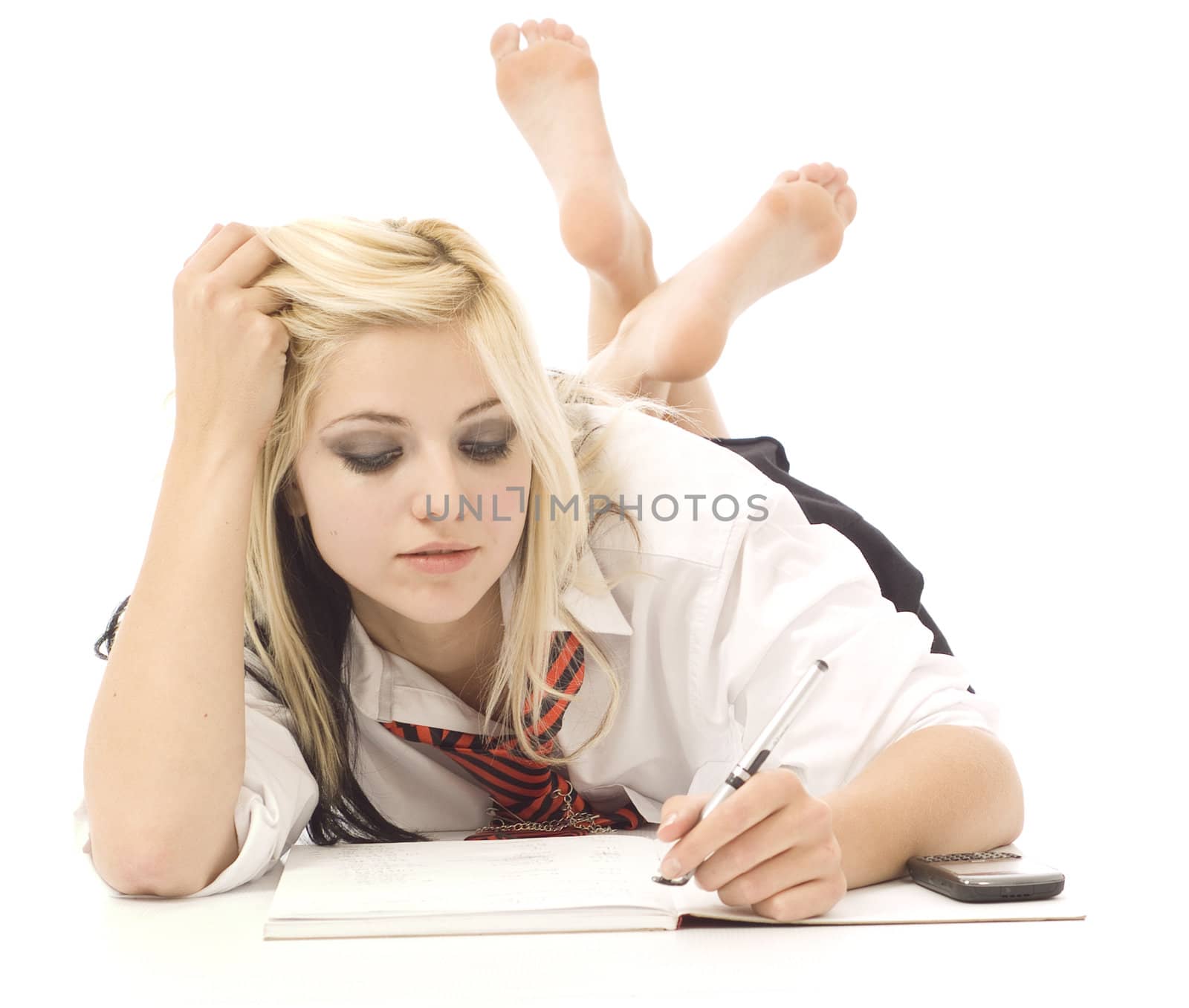 Pretty teenage school girl doing homework and cellphone