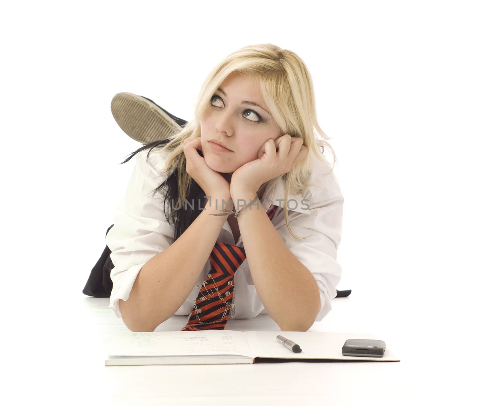 Pretty teenage school girl doing homework and cellphone