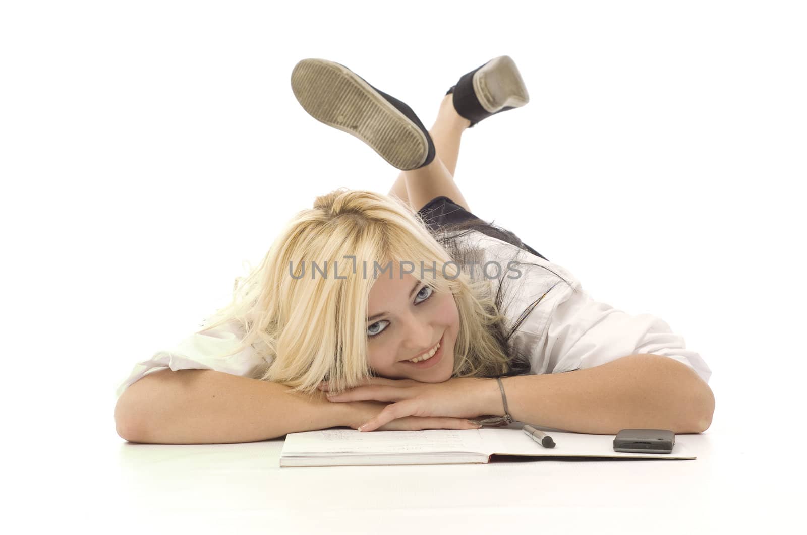 Pretty teenage school girl doing homework and cellphone