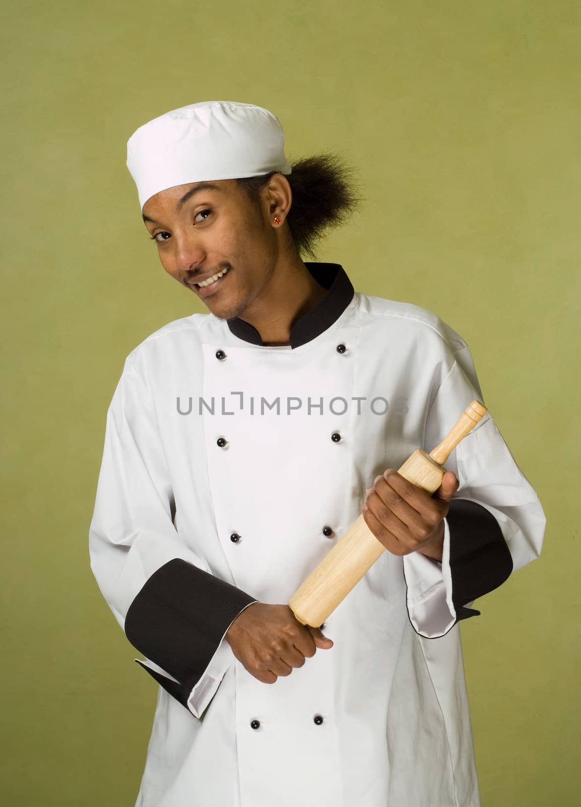 Young Handsome African American Chef Holding Rolling Pin in Hands