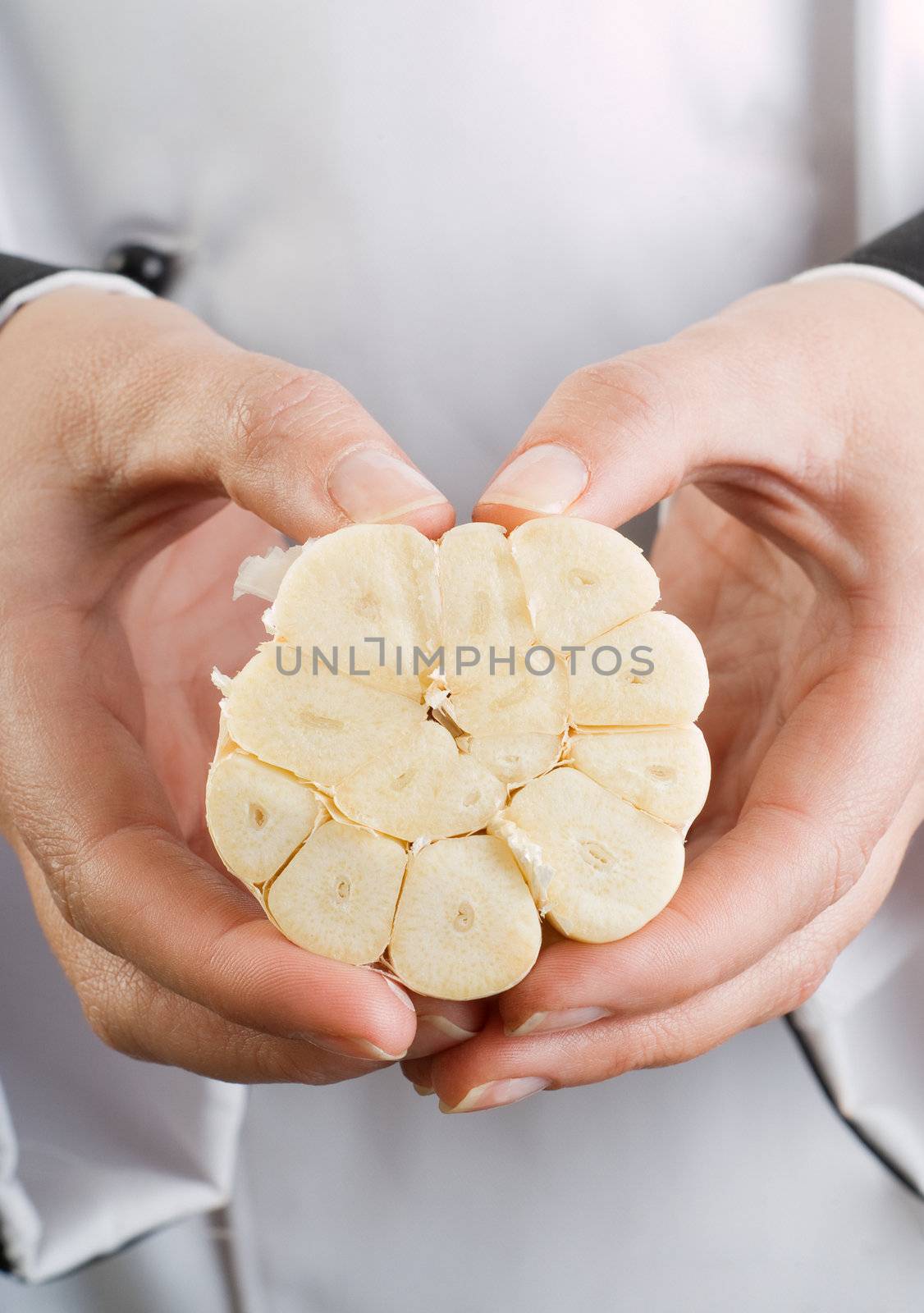 Close-Up of Chef Hands Holding Sliced Garlic