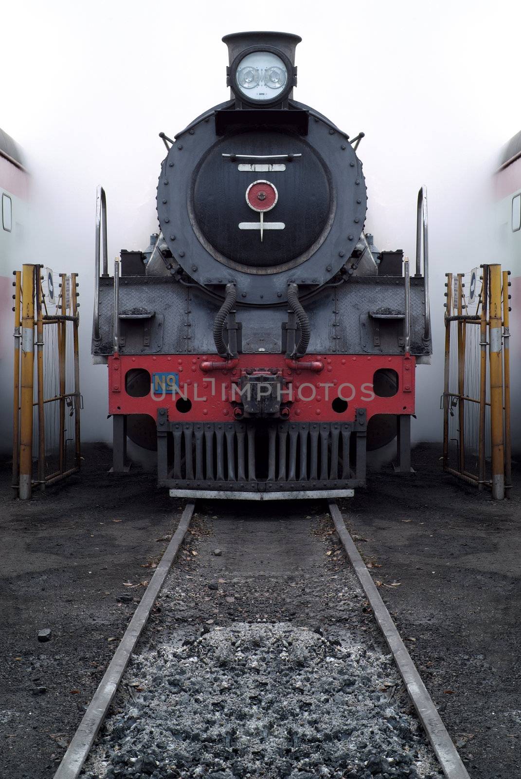 Old vinage steam train with steam and smoke in shunting yard