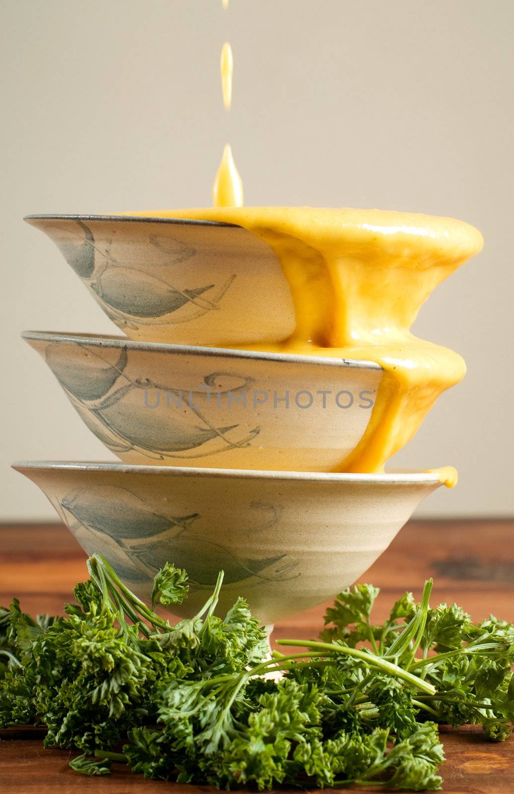 Butternut soup being poured into soup bowls