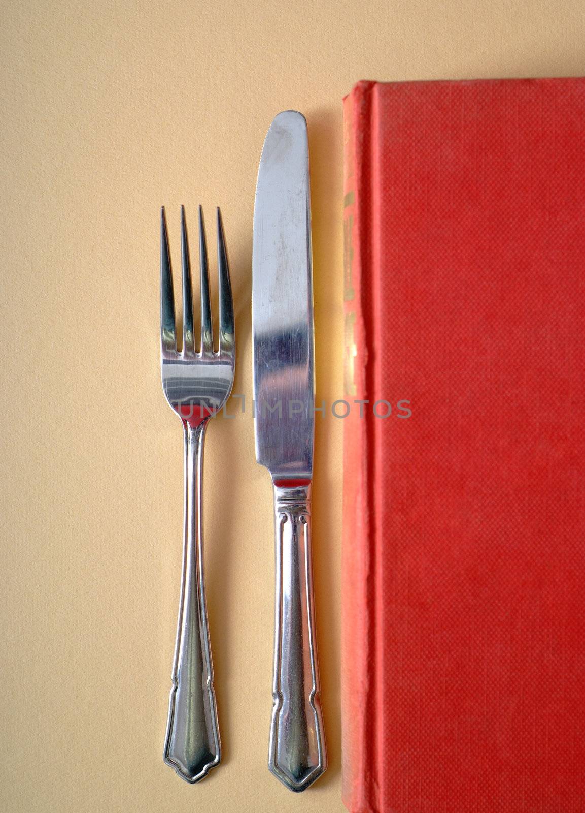 Learn by eating knowledge in book with knife and fork concept