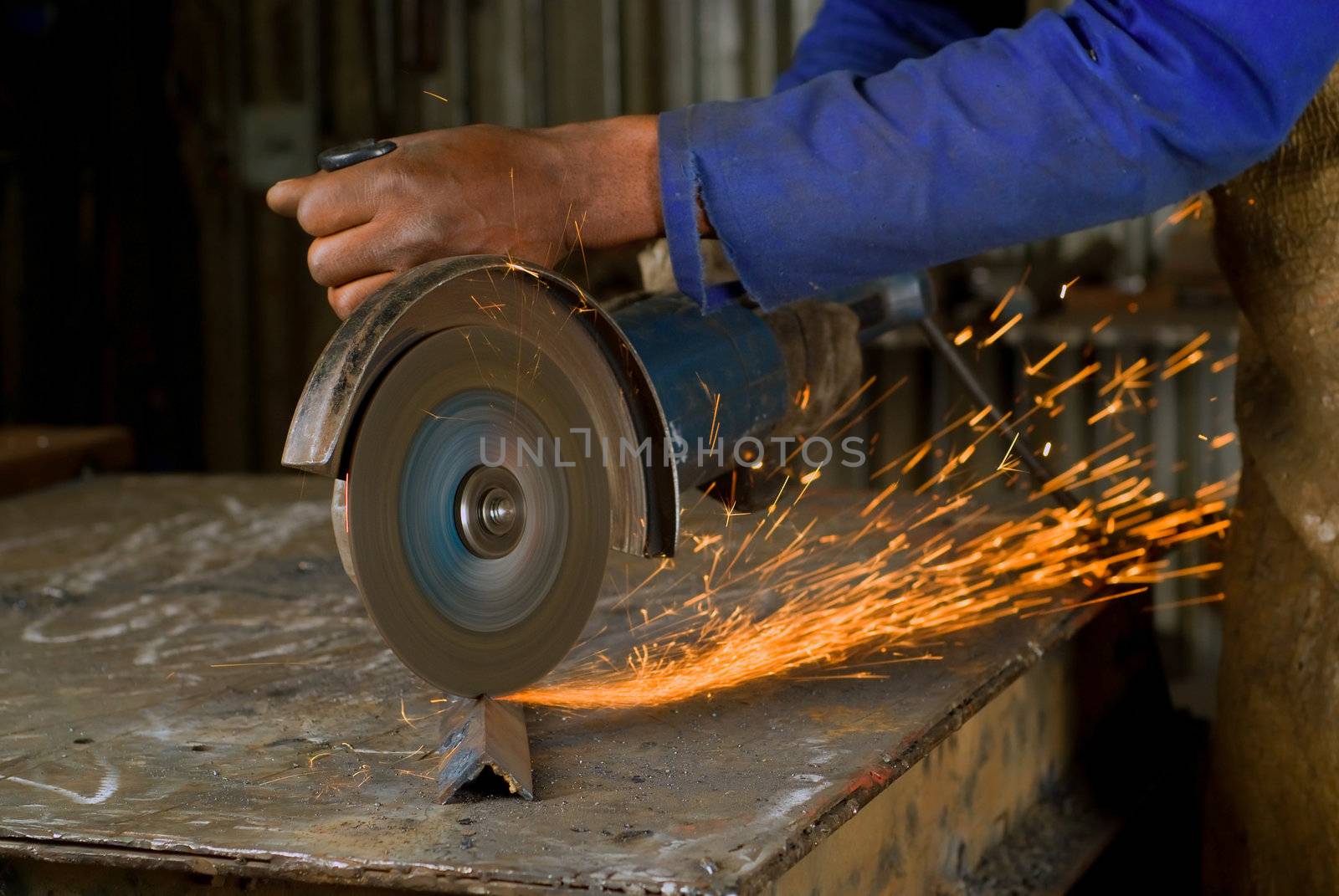 South or African American working with angle grinder