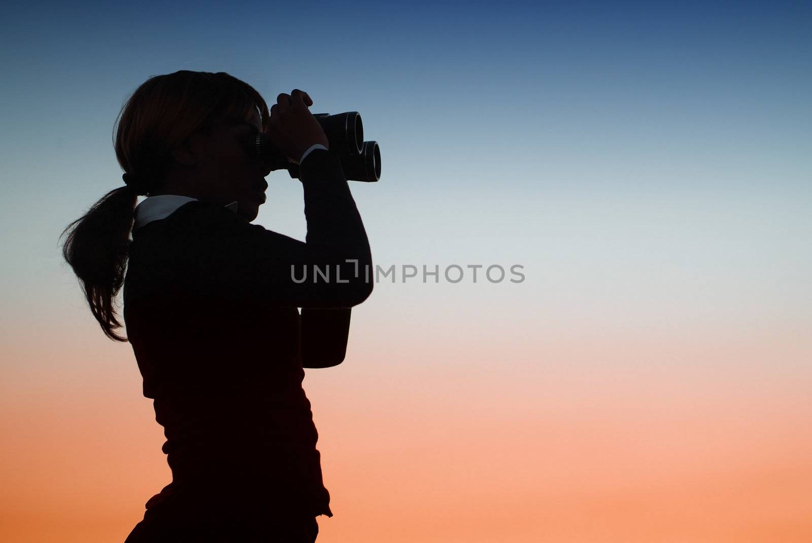 Silhouette of Business Woman with Binoculars Standing on a Hilltop
