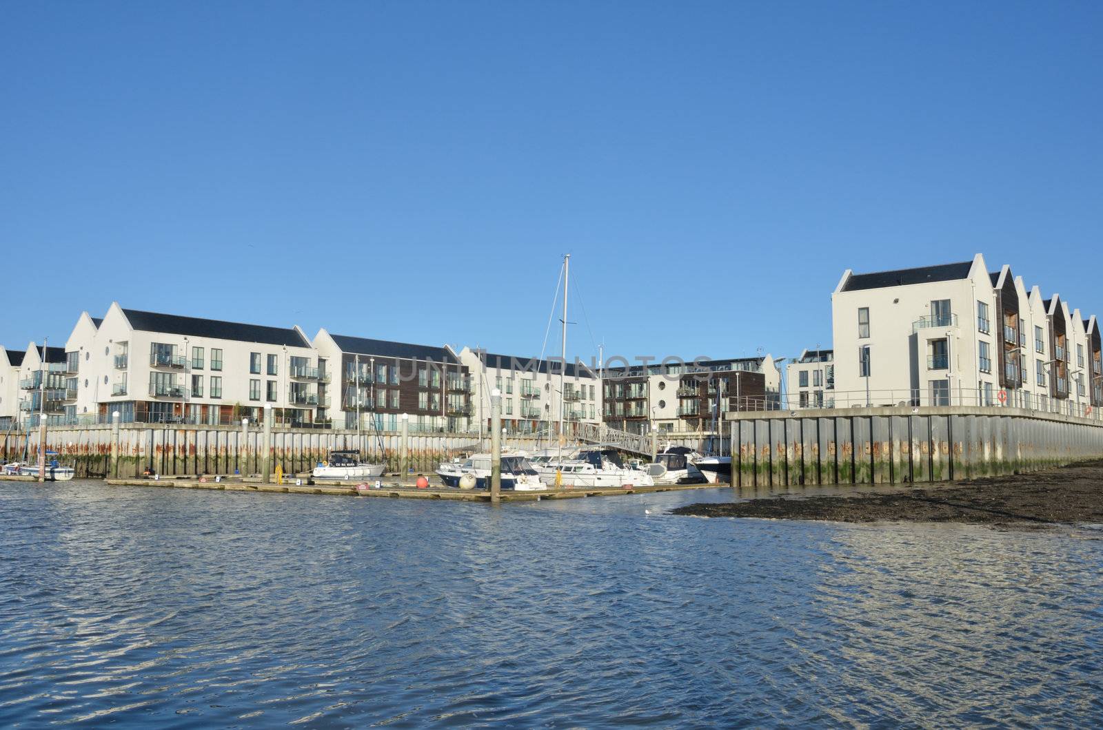 Small marina with sea in foreground