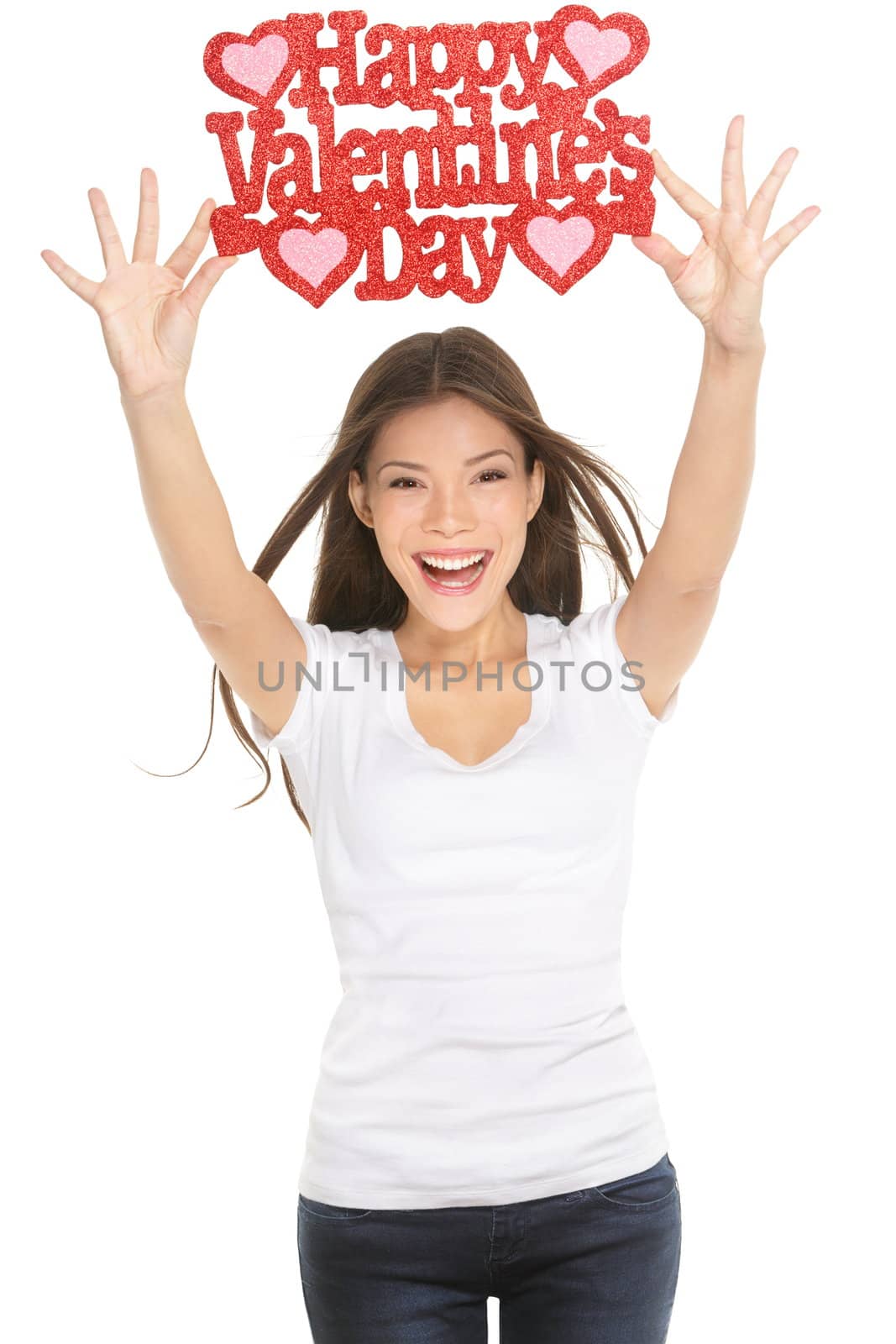Woman showing Valentines day sign smiling happy, excited and elated. Ethnic Caucasian / Asian Chinese young woman isolated and cut out on white background in studio.