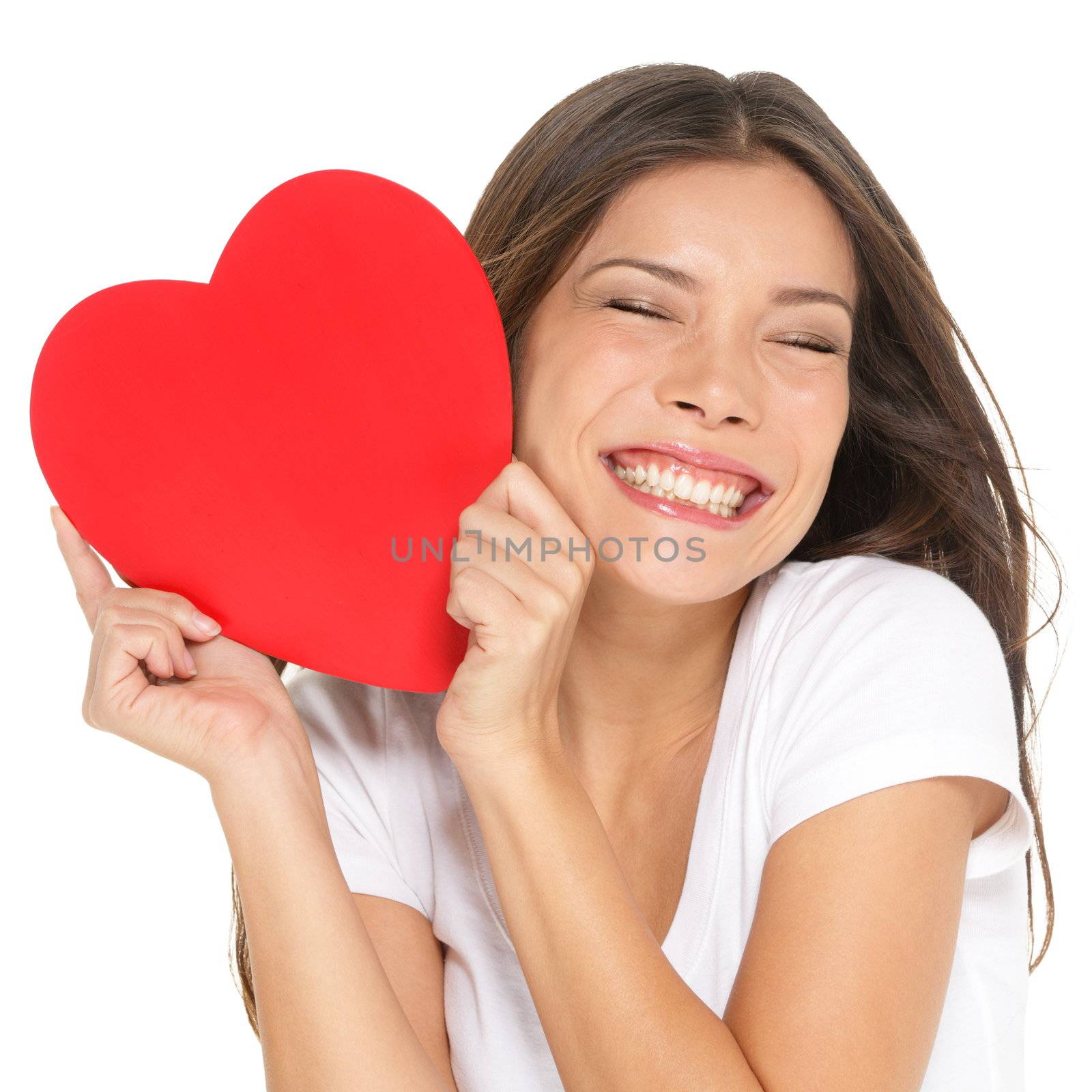 Love and valentines day woman holding heart smiling cute and adorable isolated on white background. Beautiful ethnic asian woman in love.