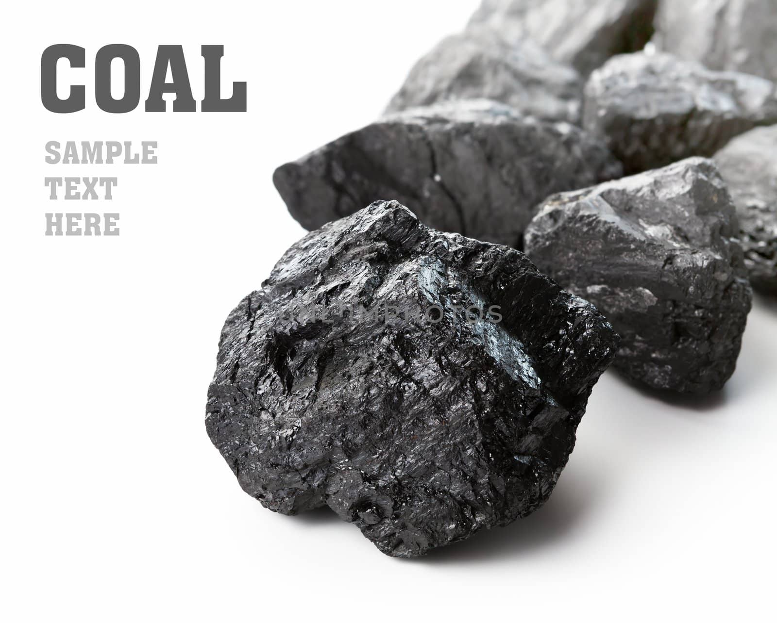 Coal lumps spilled on white background with copy space