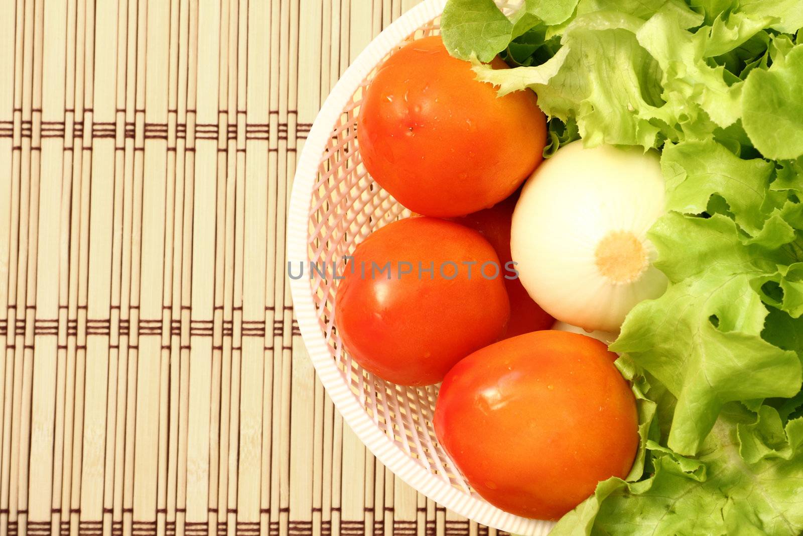 Fresh vegetable in a white basket (Tomato, Onion, Lettuce)