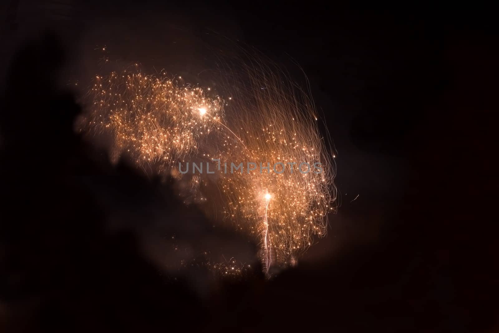 Orange fireworks in the night sky at the celebration of New year in Krivoi Rog