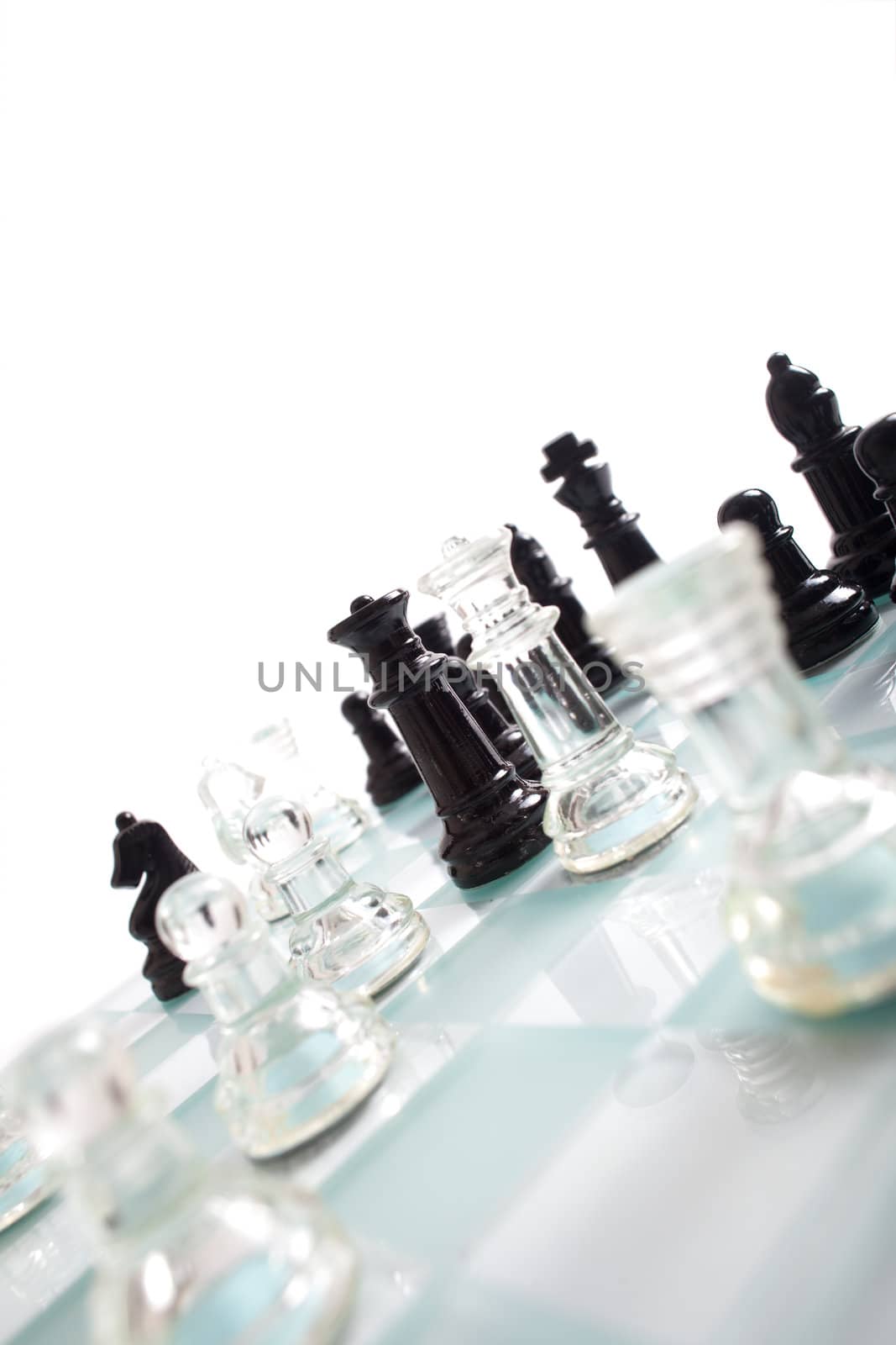 Black and transparent glass chess pieces, on a see through chessboard.