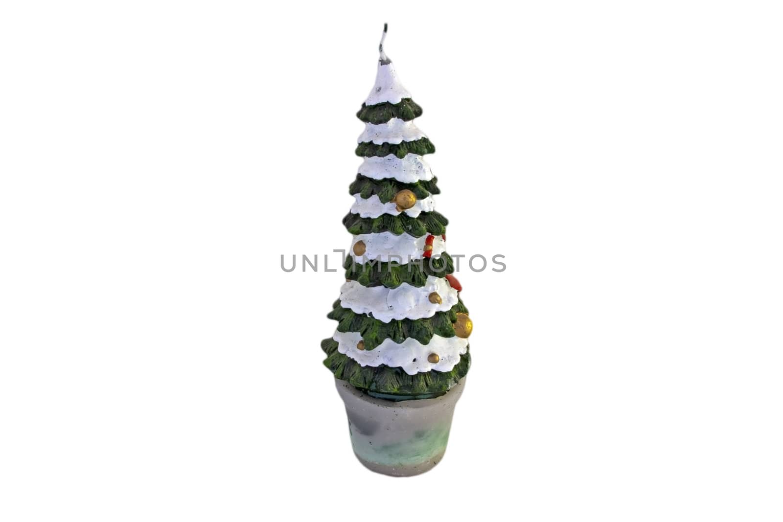 A christmas tree-shaped candle isolated on white