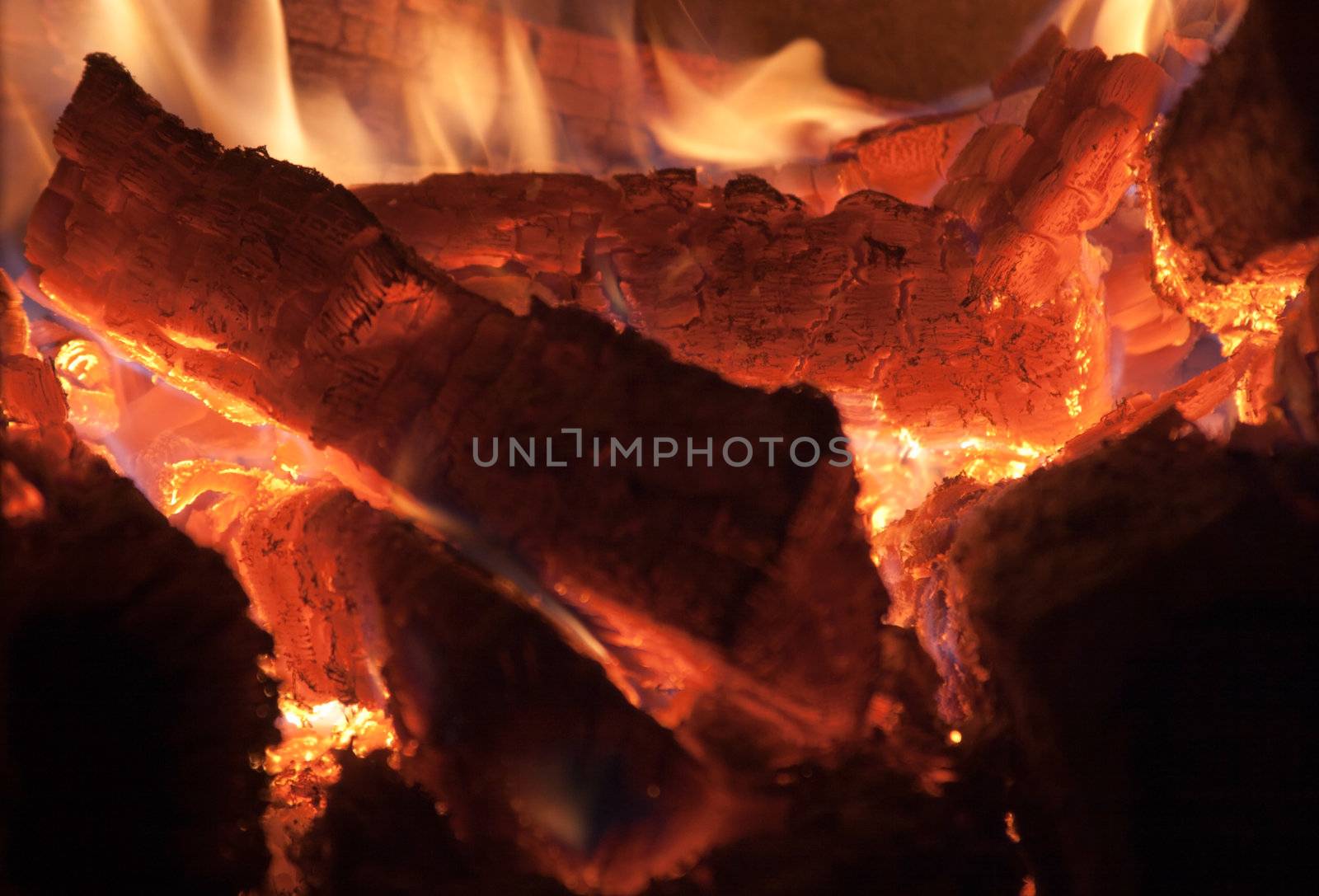 Burning logs of firewood before falling into smithereens.