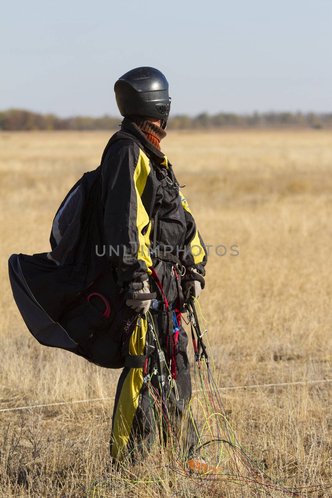 A male paraglider pilot right after landing