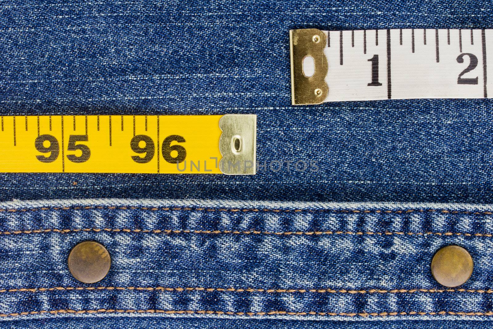 Close-up photograph of measuring tape on denim material.
