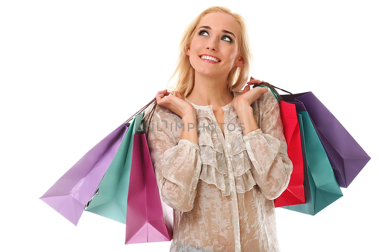 Young beautiful caucasian woman holds colorful shopping bags in her hands and smiling isolated over white background