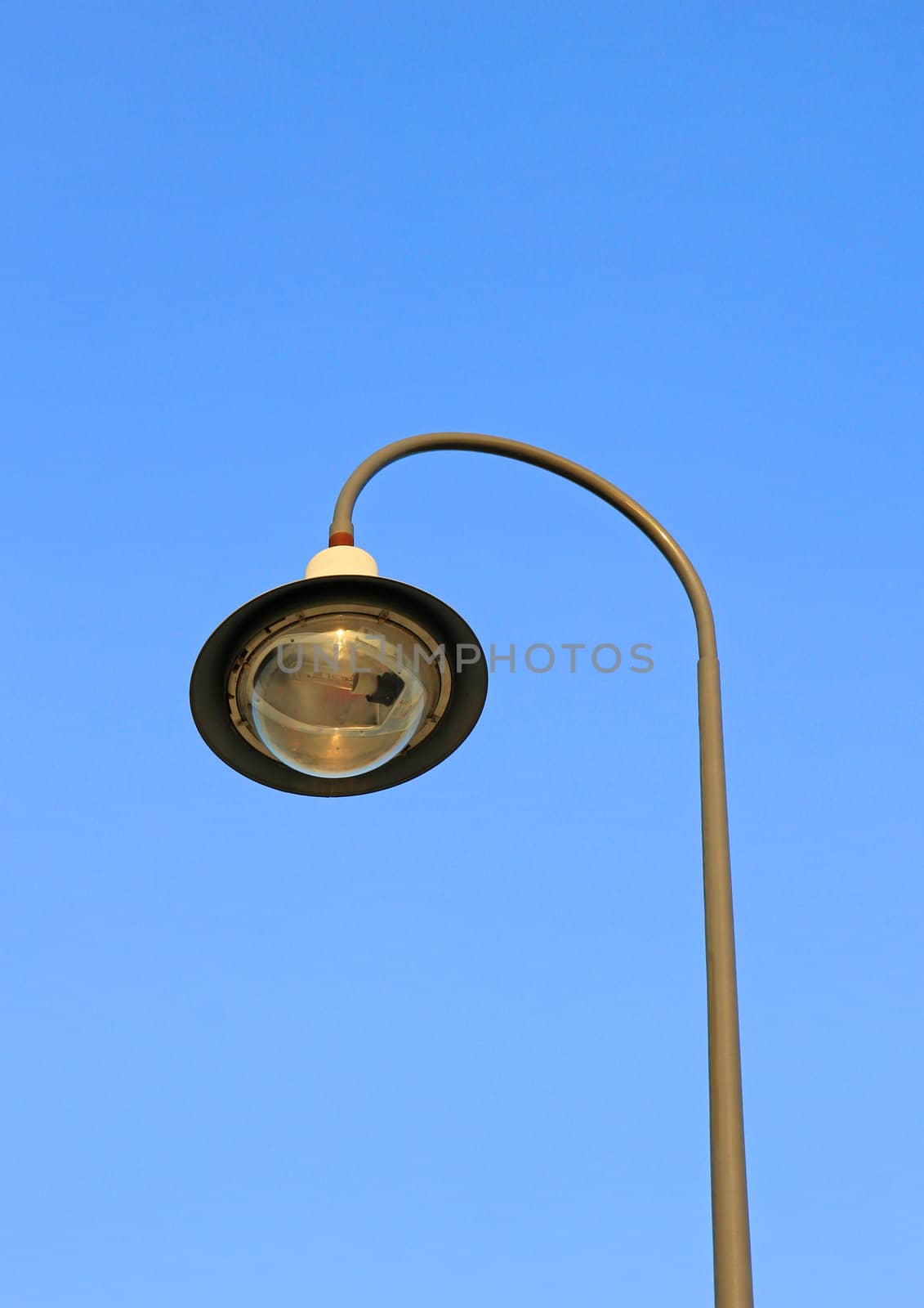 street light against a blue sky  by nuchylee