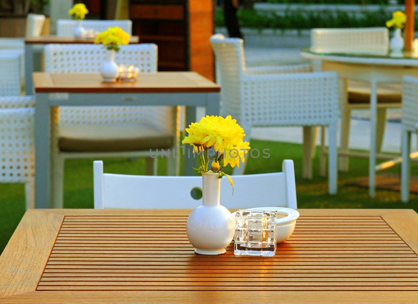 Table and chair setting with flower in outdoor restaurant by nuchylee