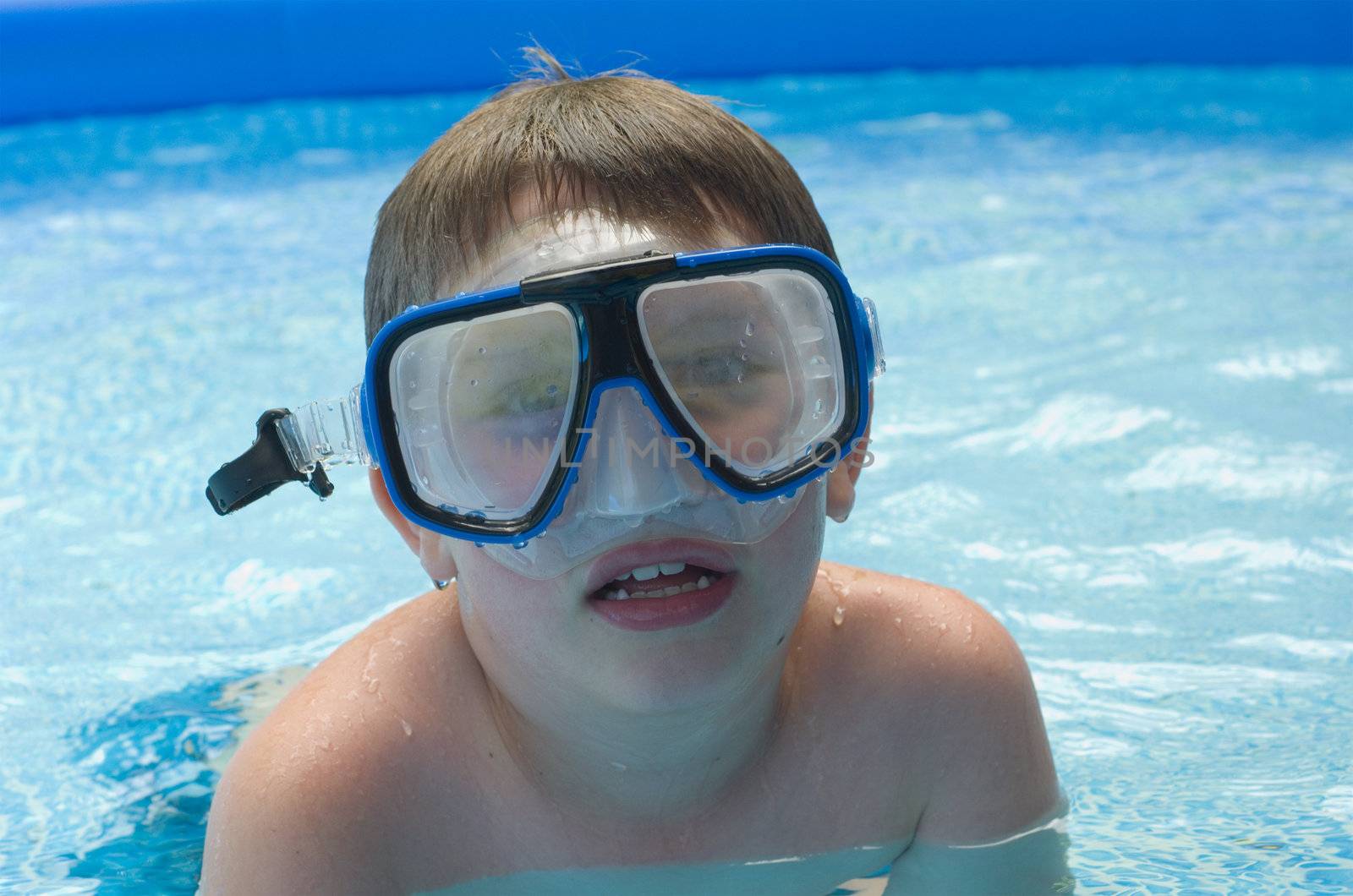 Boy in pool with diving mask