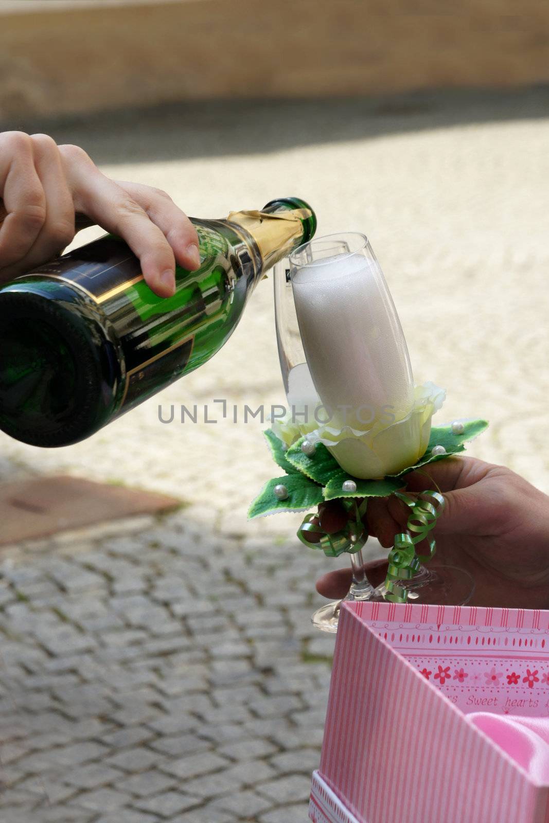 Bottle of Champagne and crystal glasses in the man hands                    