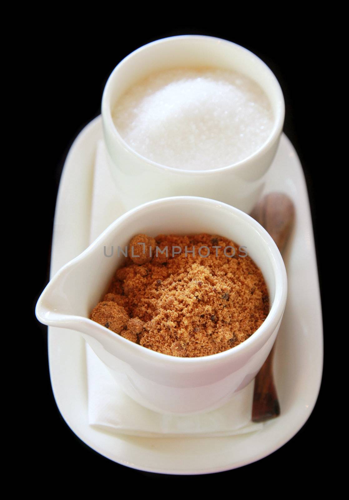 Brown and white sugar in cup with wooden spoon