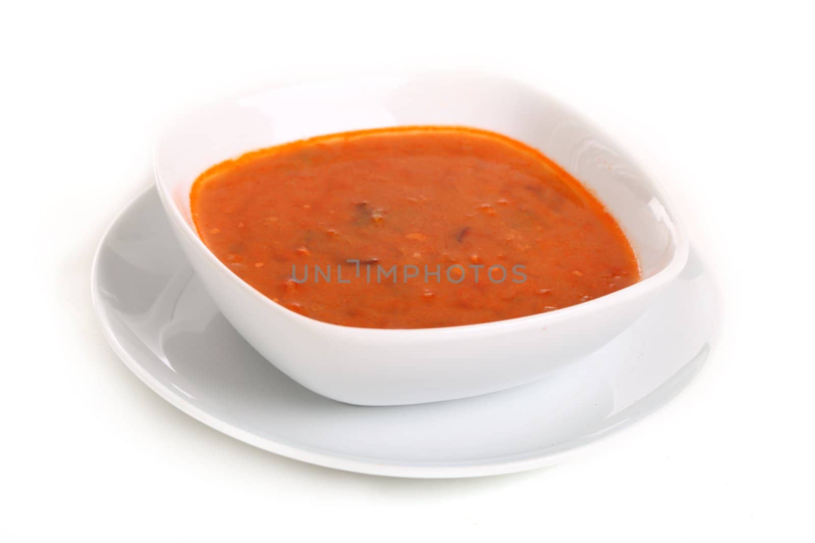 Image of bowl of hot red soup isolated on white background