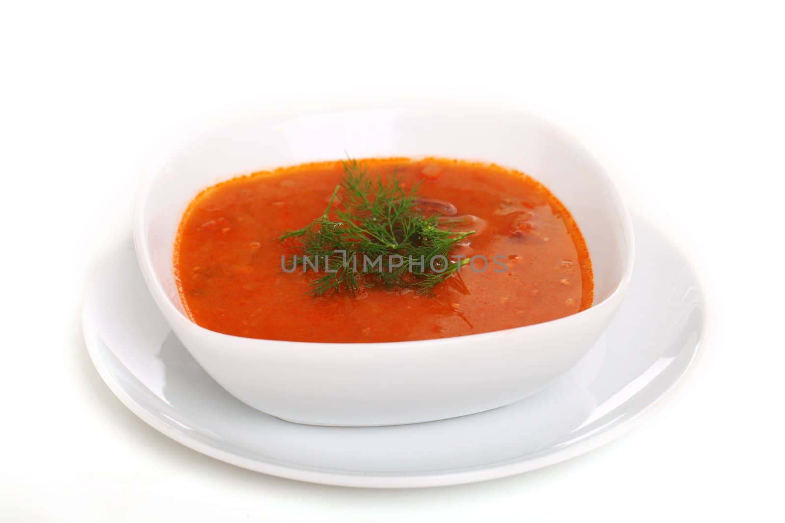 Image of bowl of hot red soup isolated on white background