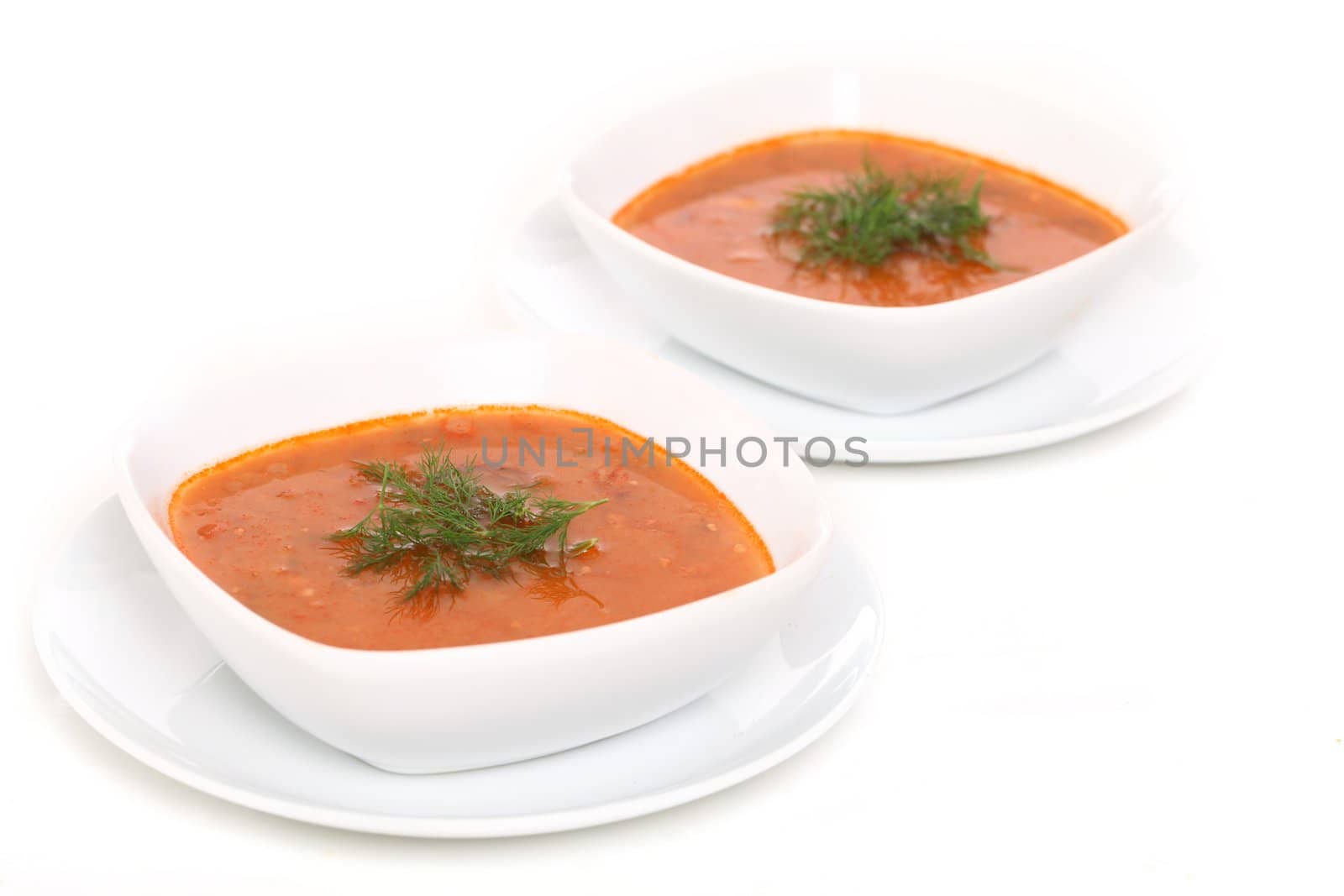 Image of two bowls of hot red soup isolated on white background