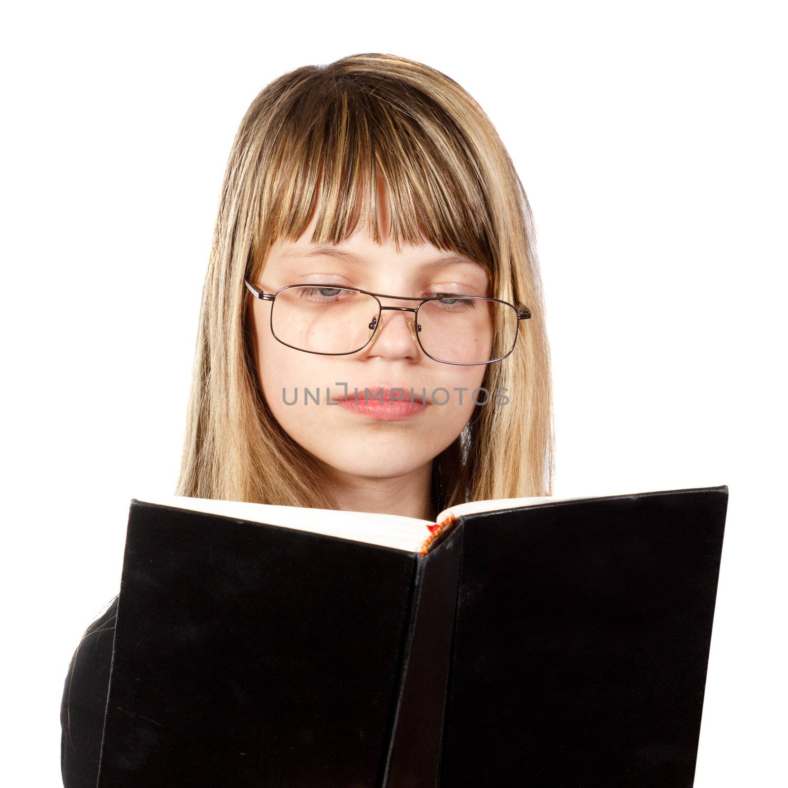 teenage girl with big glasses reading a black book against white background