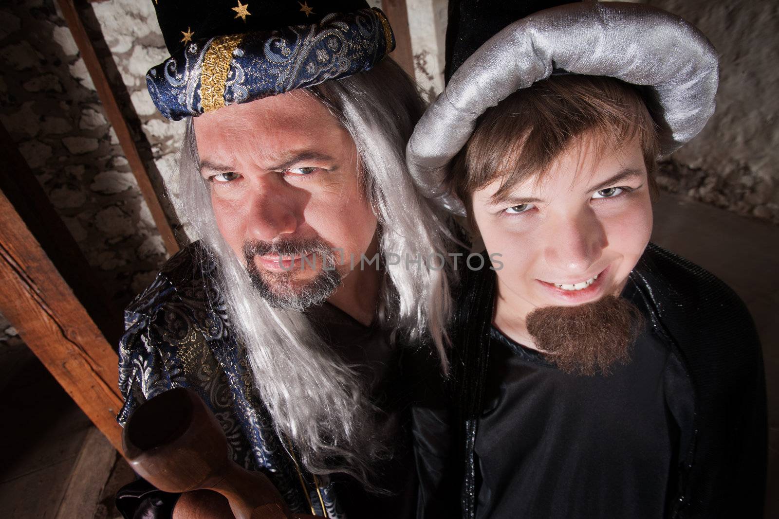Caucasian father and son wizards standing next to each other