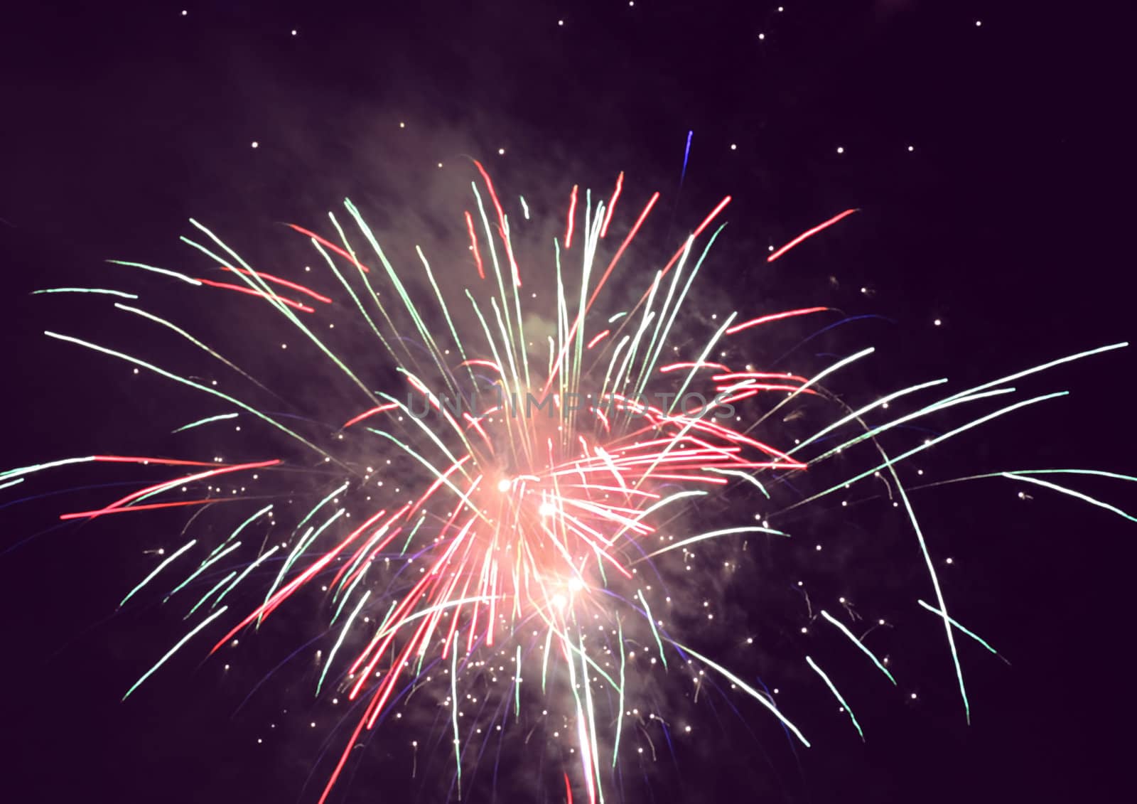 bright holiday fireworks in night sky