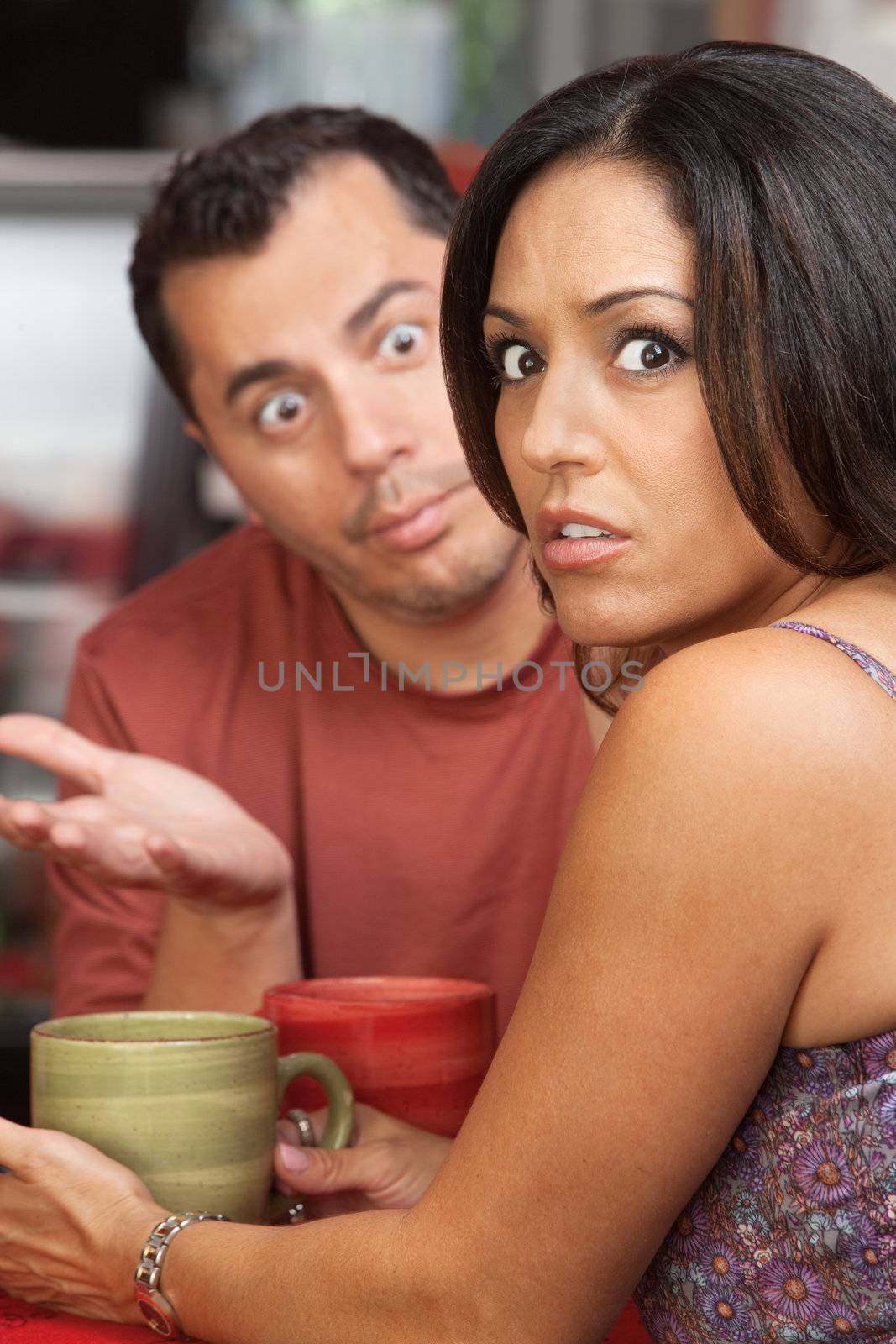 Embarrassed woman arguing a in a restaurant with man
