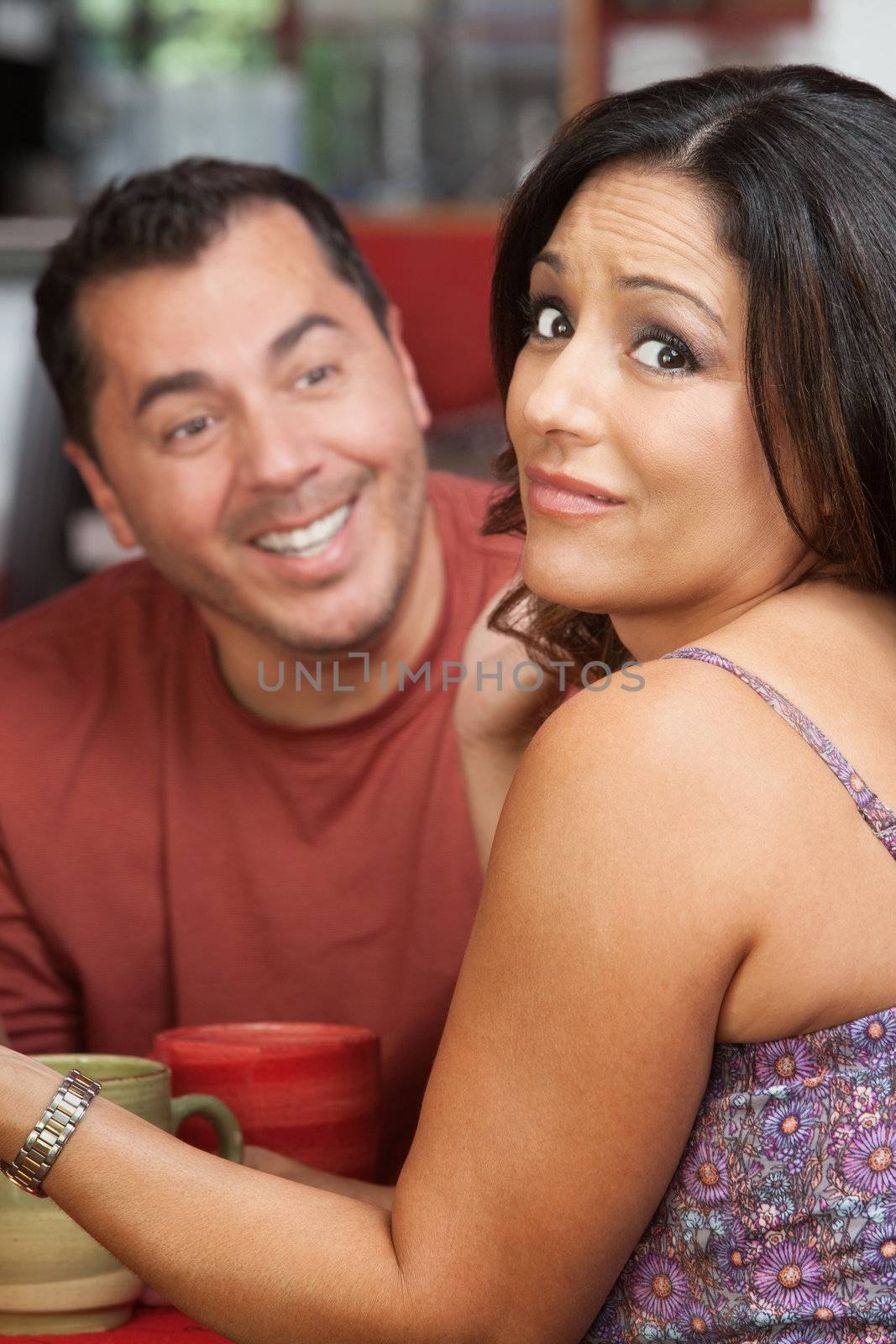 Man flirting with attractive Mexican female in a cafe