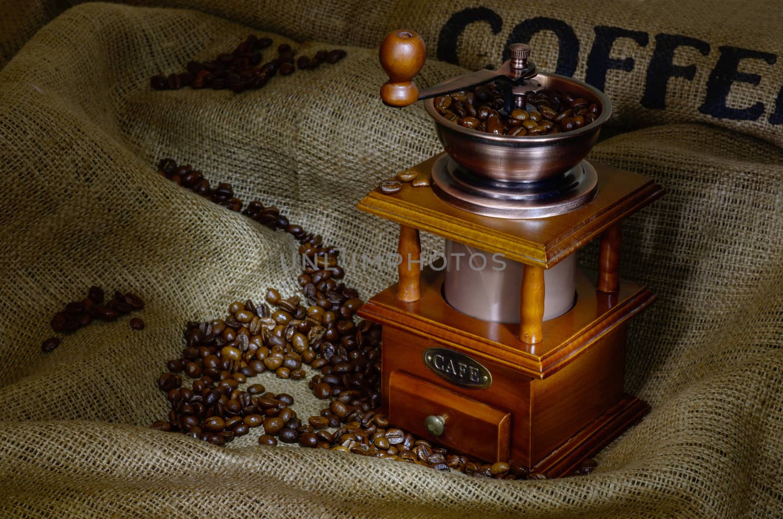 Coffee Mill with beans and burlap. still life