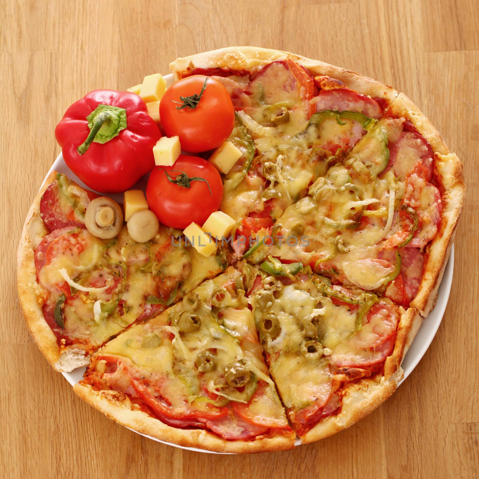 Fresh italian pizza in plate on a wooden surface