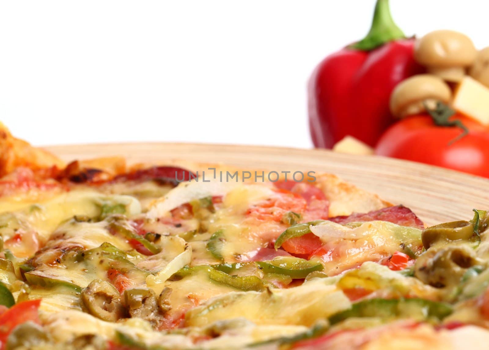 Image of sliced pizza in a plate and vegetables isolated over white background