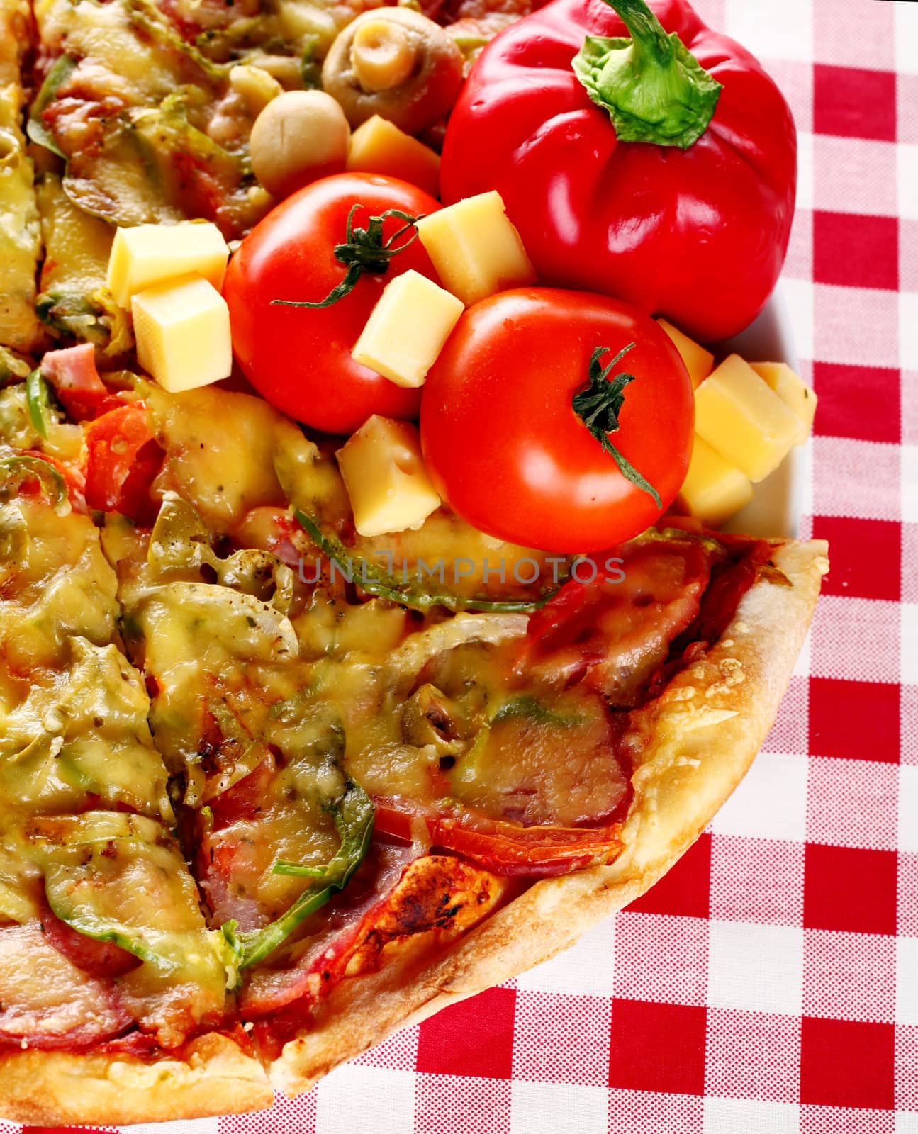 Image of fresh italian pizza on a squared tablecloth