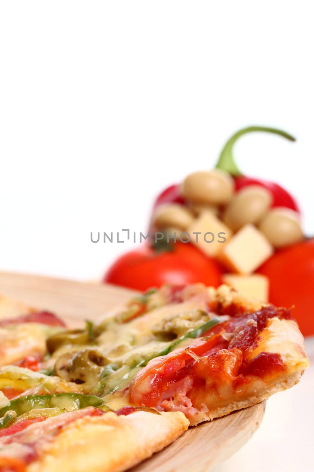 Image of sliced pizza in a plate and vegetables isolated over white background