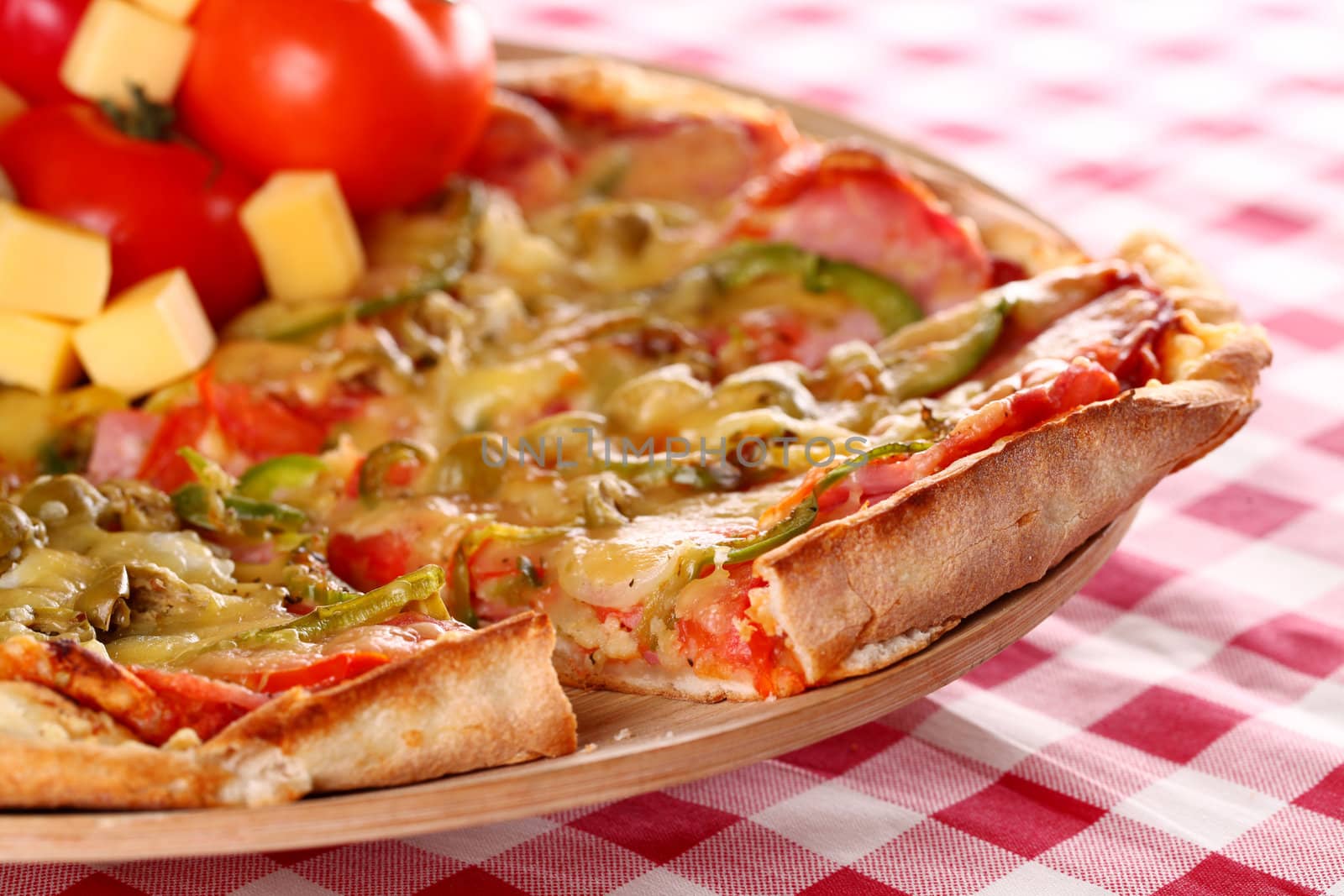 Image of fresh italian pizza on a squared tablecloth