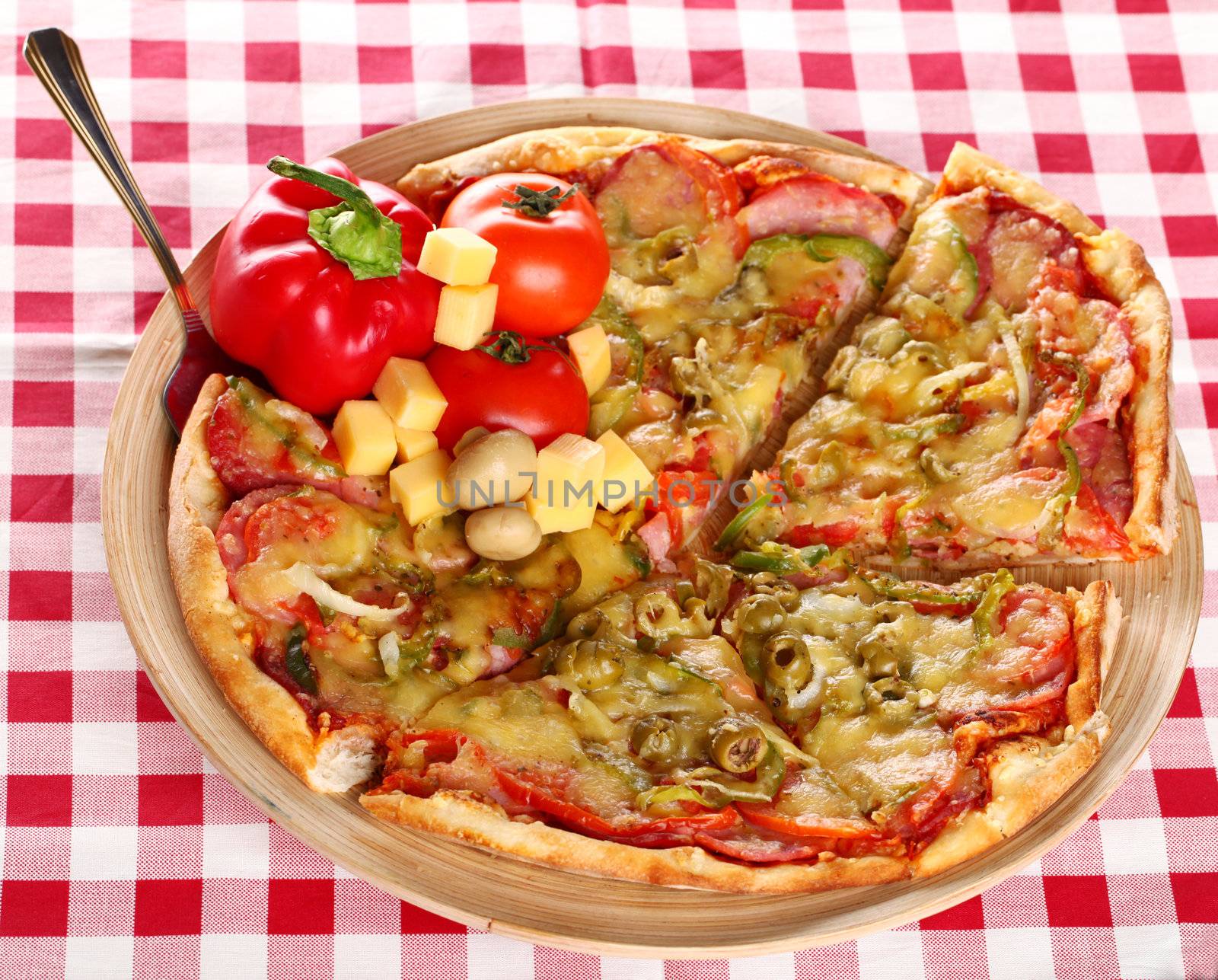 Image of fresh italian pizza on a squared tablecloth