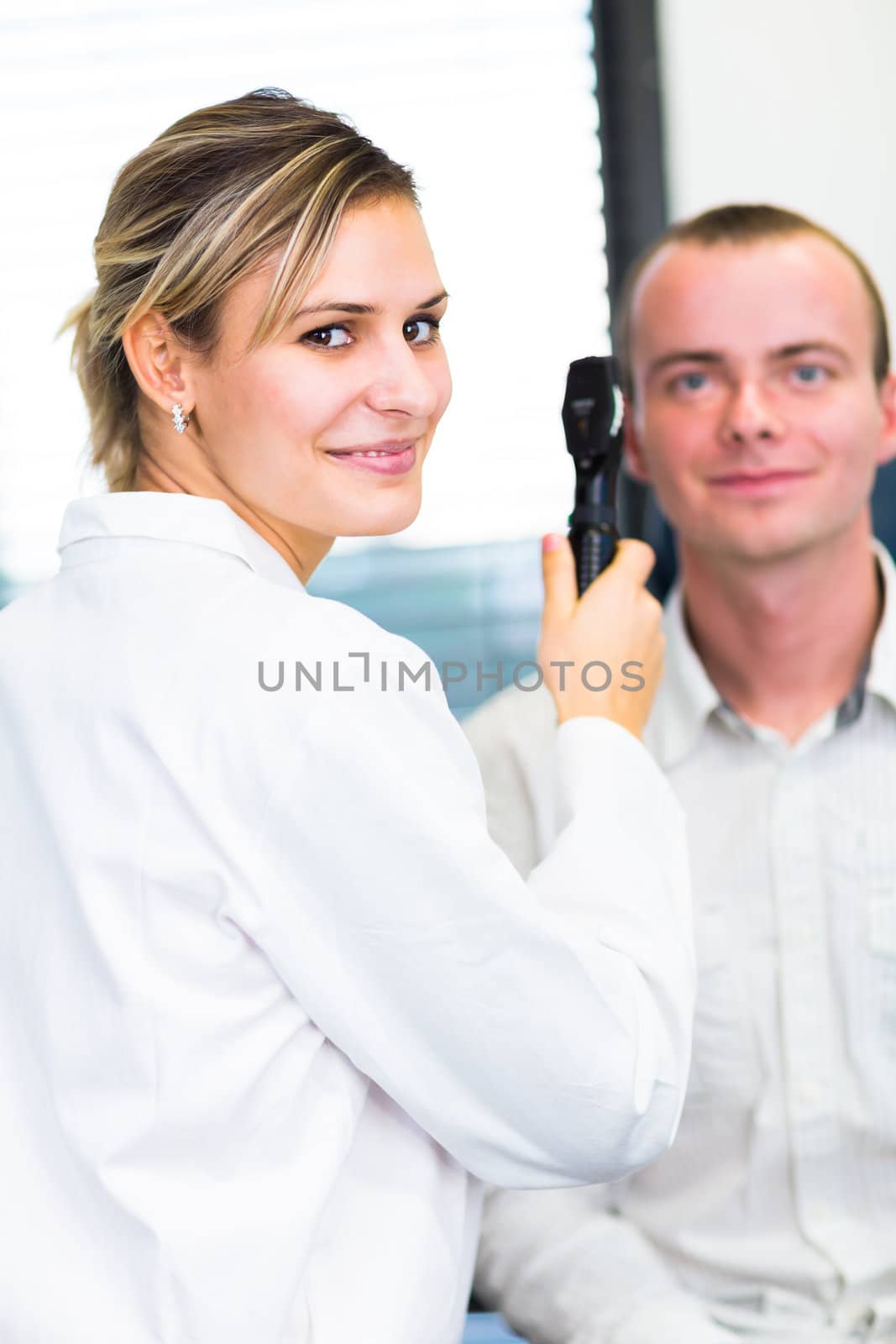 Optometry concept - handsome young man having her eyes examined  by viktor_cap