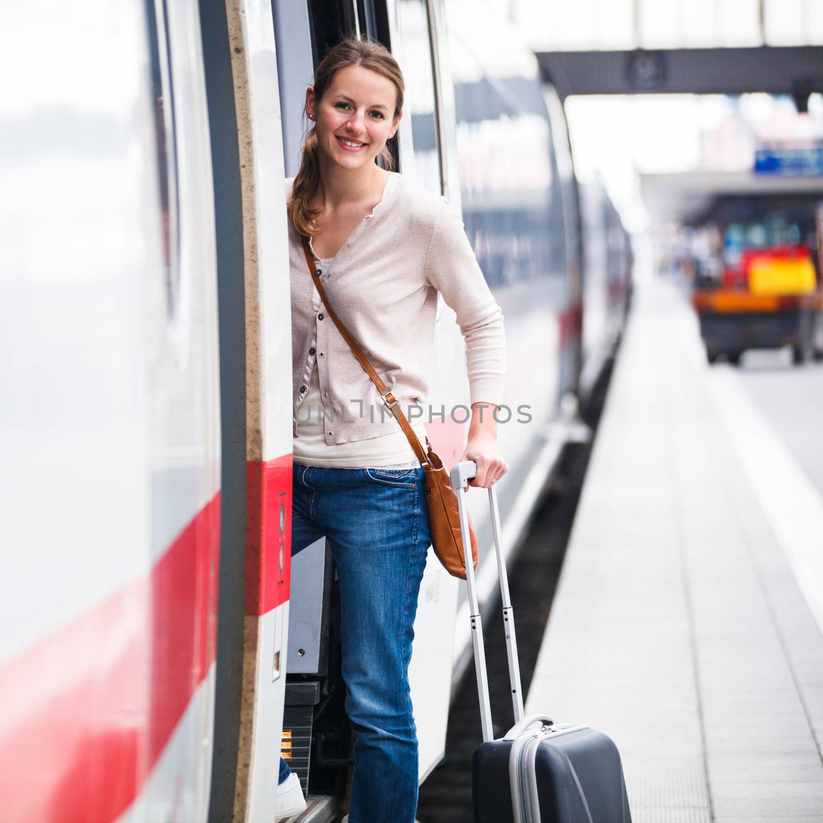 Pretty young woman boarding a train by viktor_cap