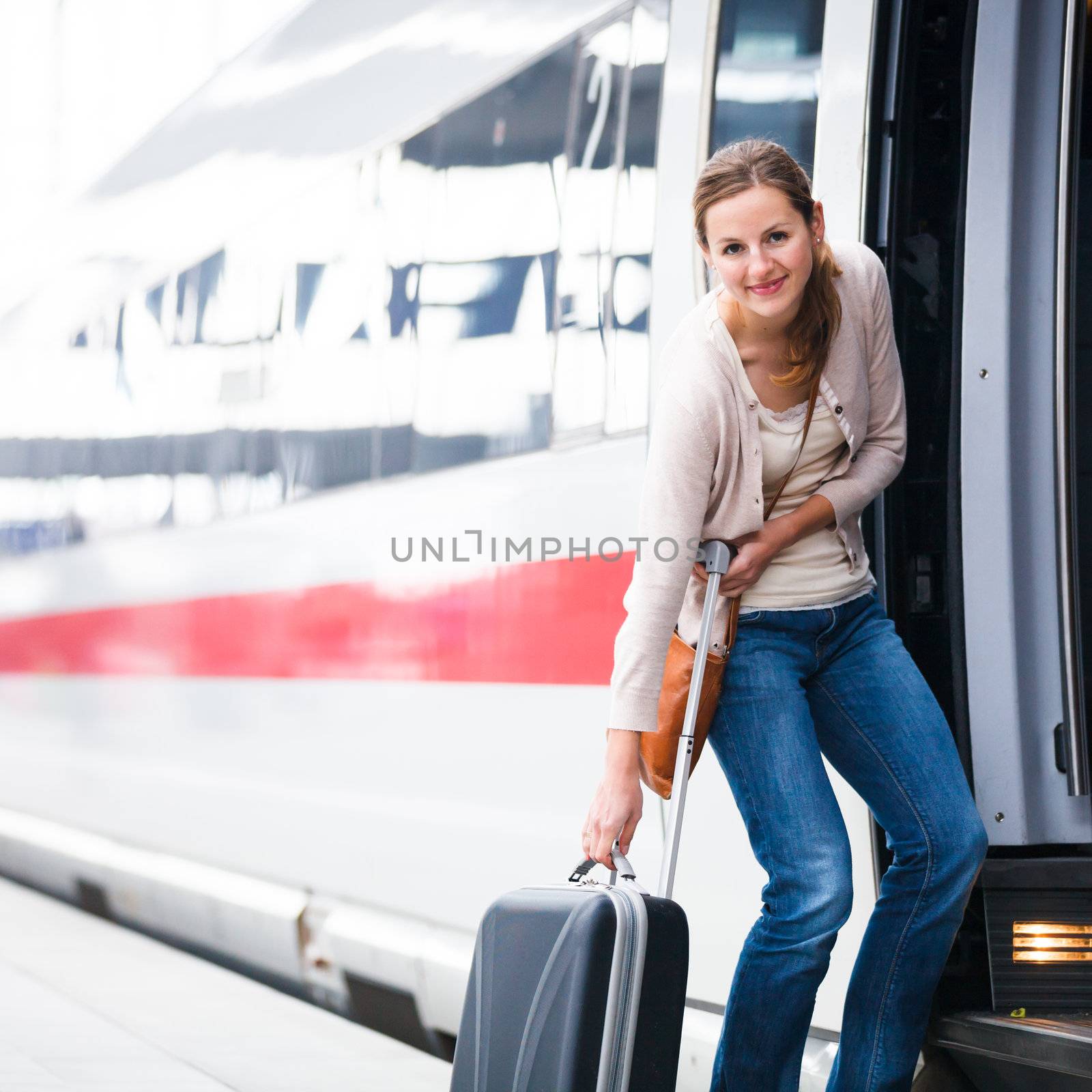 Pretty young woman boarding a train by viktor_cap